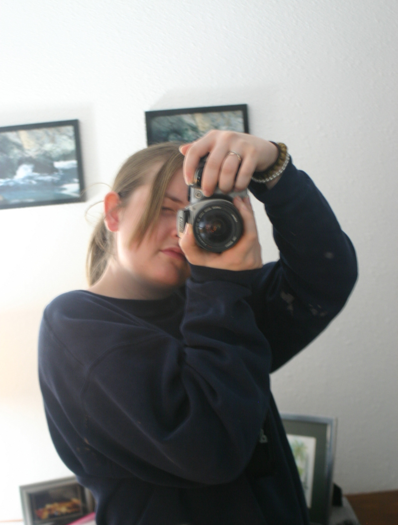 Casie taking a pictures of herself in a mirror with a SLR camera