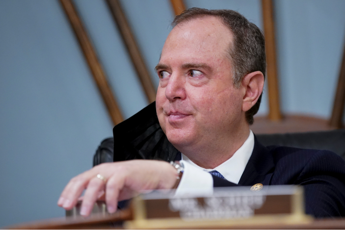 Adam Schiff looking sideways behind desk